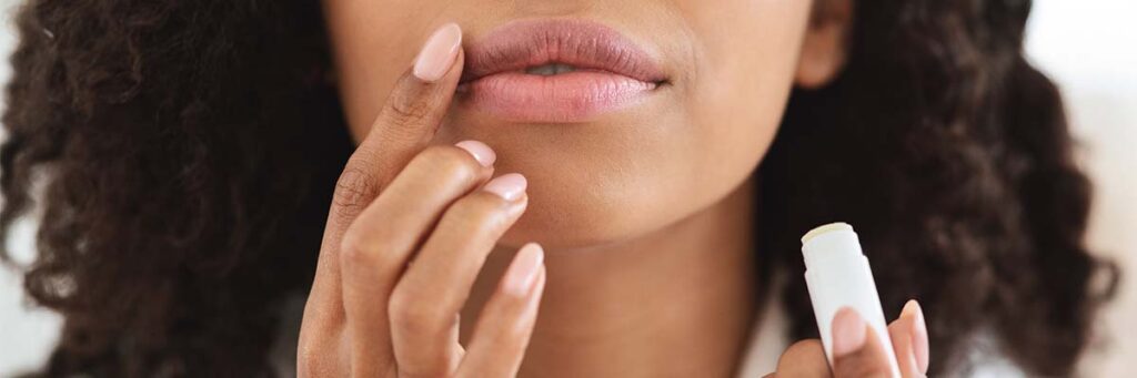 woman applying lip balm